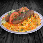 Spiced Halal tandoori chicken and rice platter on dark wood